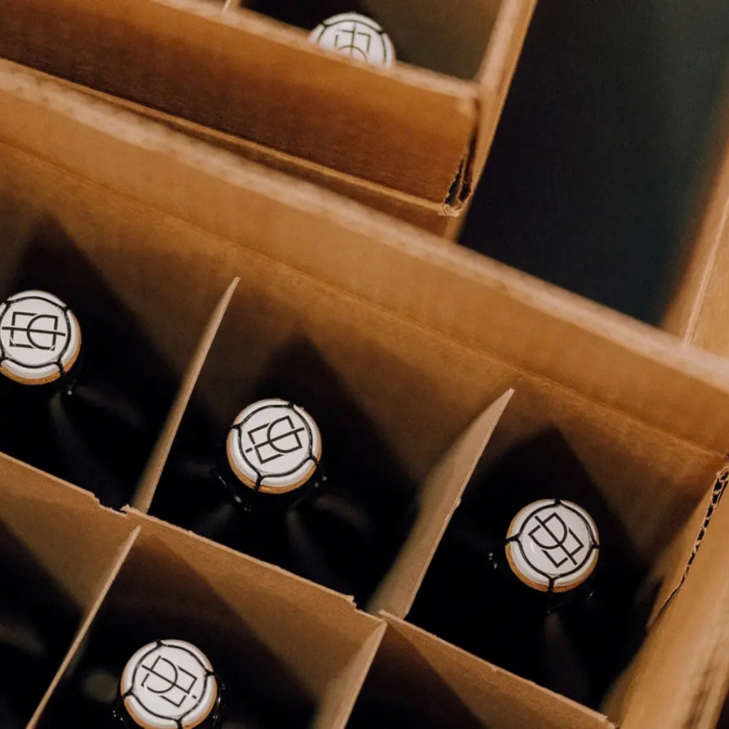 Wine bottles organized into boxes.