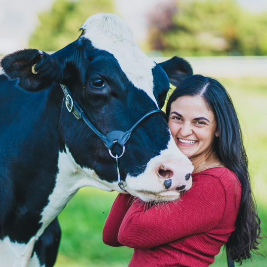 Portrait of Pappy's Farm owner with a cow