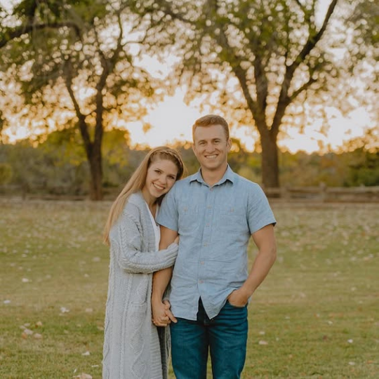 Rove & Ramble – Headshot Headshot of a couple in an open grassy area